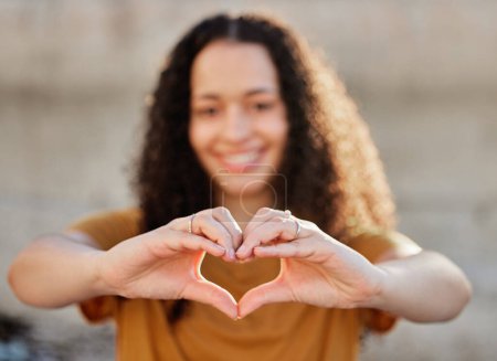Photo for Smile, heart hands and portrait of woman for love, positive and support against wall. Happiness, gesture and face of gen z female person for emoji, symbol of kindness or affection in outdoor. - Royalty Free Image
