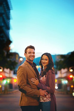 Photo for Street, portrait and couple in night, date and hug or embrace for romance, bokeh and New York. Weekend, man and woman in dark on road, anniversary and smile in city, happiness and relationship. - Royalty Free Image