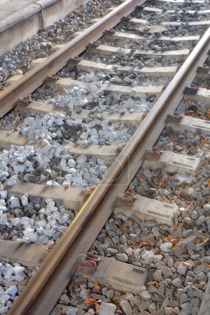 Railway, track and stone on ground for train, transport and commute on earth in environment. Metal, lines and pebbles for travel, move and carriage for engine, locomotive or journey in industry.