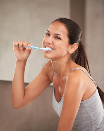 Health, bathroom and portrait of woman with toothbrush for cleaning, oral hygiene and dental care in home. Toothpaste, healthcare and person brushing teeth for whitening, wellness and grooming.