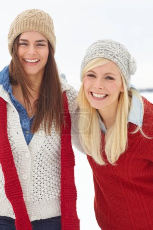 Portrait, lesbian couple and snow in winter on holiday is Alaska for Christmas, festive and travel for bonding. Cheerful, women and laugh with happiness, fun and love for vacation, break or retreat.