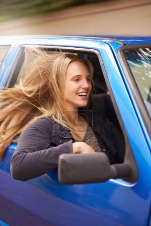 Photo for Road trip, travel and woman with wind in car for adventure, journey and commute for vacation, freedom and holiday. Transport, happy and excited person in vehicle for fun, driving and relax on street. - Royalty Free Image