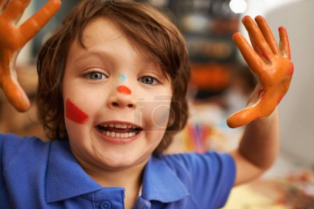 Photo for Happy boy, portrait and hands with face paint for artwork, craft or creativity at elementary school. Little male person, child or kid with smile for colorful art, youth or early childhood development. - Royalty Free Image