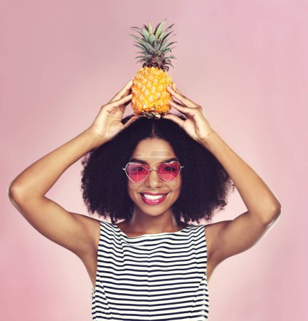Photo for Studio, portrait and black woman with pineapple, diet and detox on pink background. Eyewear, nutrition and gut digestion for weight loss and vitamins for female model, vegan and vitamin c for fiber. - Royalty Free Image