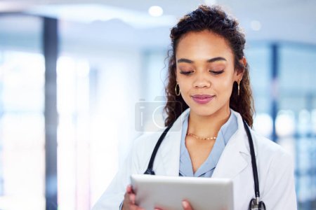 Photo for Professional, woman and doctor with tablet in hospital for research, information and patient results as specialist. Female person, technology and surgeon for diagnosis or treatment with Telehealth. - Royalty Free Image