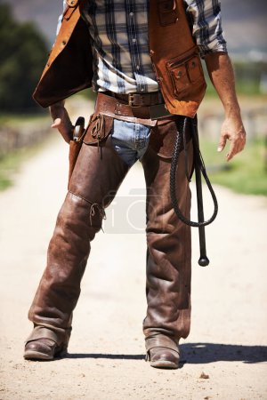 Person, outdoors and gun ready to shoot for standoff or gunfight in duel for wild western culture in Texas. Cowboy gunslinger or outlaw, revolver and confrontation for defense or conflict with battle.