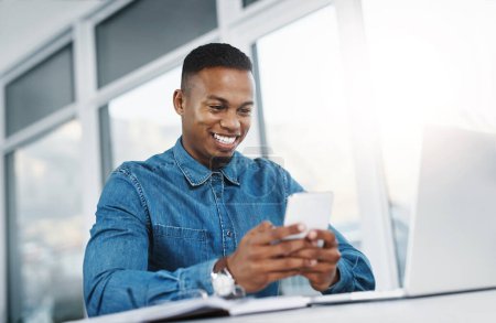 Photo for Smile, smartphone and black man by computer in office, workspace and desk happy in creative career. Communication, internship and journalist with tech for contact, research and internet for working. - Royalty Free Image
