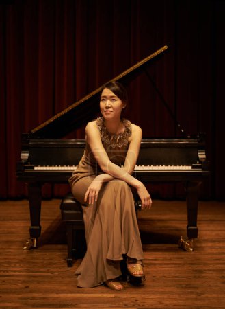 Photo for Stage, concert and portrait of woman with piano for performance, entertainment and talent show. Musician, creative artist and Asian person with instrument for melody, classical music and symphony. - Royalty Free Image