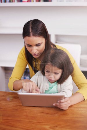 Photo for Internet, home and mother with girl, tablet and digital app with connection and smile with website. Bonding together, family or mama with daughter or relax with tech, game or typing with social media. - Royalty Free Image