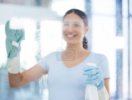 Photo for Happy woman, cleaner and window with spray bottle for disinfection, hygiene or health and safety at office. Female person, domestic or young maid with smile for glass, surface or cleaning service. - Royalty Free Image