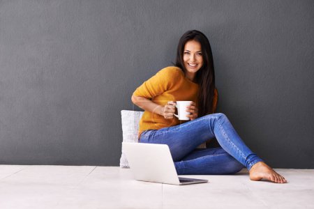 Photo for Woman, laptop and portrait or cup in home, website and coffee or tea on floor of living room. Female person, mockup space and wall background for freelancer, plan and remote work in apartment on app. - Royalty Free Image