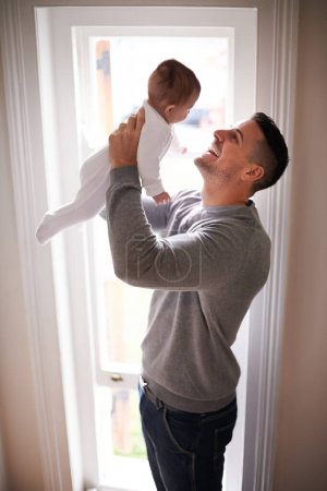 Photo for Father, baby in air and bonding, happy with love for growth and child development with joy at family home. Man, infant or newborn with smile and dad holding kid for comfort, childhood and parenting. - Royalty Free Image