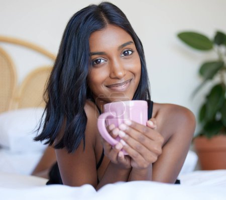 Photo for Breakfast, bed and Indian woman with coffee, portrait and smile in morning, relax and happiness in hotel. Vacation, break and holiday for girl, drink and beverage of espresso, resort and bedroom. - Royalty Free Image