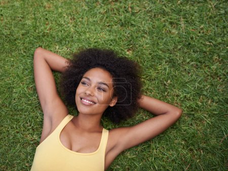 Photo for Happy, grass and above of black woman in park for thinking, wondering and relax in nature. Smile, garden and top view of person laying outdoors for holiday, vacation and weekend for calm or peace. - Royalty Free Image
