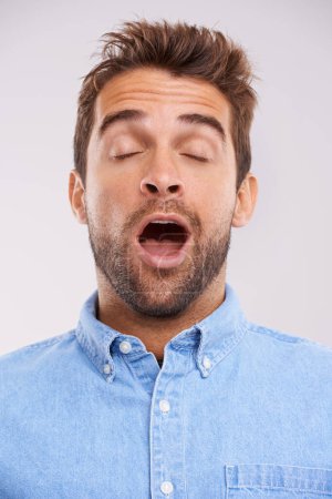 Photo for Man, eyes closed and yawn, tired in studio and burnout with facial expression and insomnia isolated on white background. Face, open mouth and fatigue with exhaustion, overworked and sleepless. - Royalty Free Image