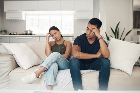 Stress, divorce or couple fight on sofa with anxiety, fear or frustrated by liar, fail or drama at home. Marriage, conflict or asian people argue in living room with blame, overthinking or mistake.