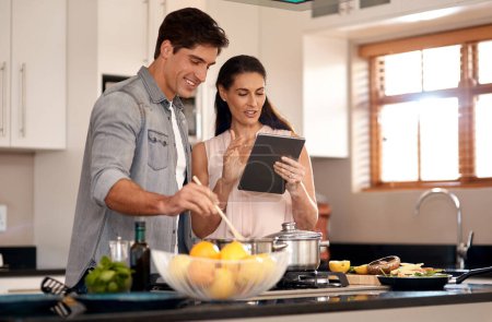 Photo for Couple, cooking and tablet for recipe, kitchen and home with online, cheerful and making dinner. Food, digital and together with internet, family and nutrition while streaming, social media and learn. - Royalty Free Image