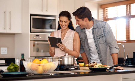 Photo for Couple, kitchen and cooking with online video on tablet, wellness and nutrition. Marriage, man and woman cut or read instructions on the internet, food website or blog and prepare meal for dinner. - Royalty Free Image