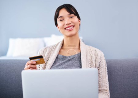 Photo for Credit card, woman and laptop on sofa for online shopping, portrait and budget in apartment. E-commerce, payment and digital banking in house for paying bills, loans and upgrade for streaming - Royalty Free Image