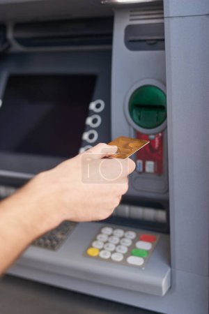 Photo for Card, hand and atm in bank for withdrawal, cash and payment or deposit in savings account. Machine, person and transaction for money, balance and transfer with insurance against theft, fraud and scam. - Royalty Free Image