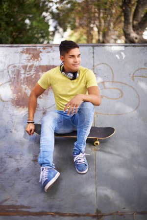 Photo for Fashion, thinking and man with skateboard in skate park for exercise, training and skating in city. Skater, fitness and person in trendy, casual and street style for sports, fun hobby and relax. - Royalty Free Image