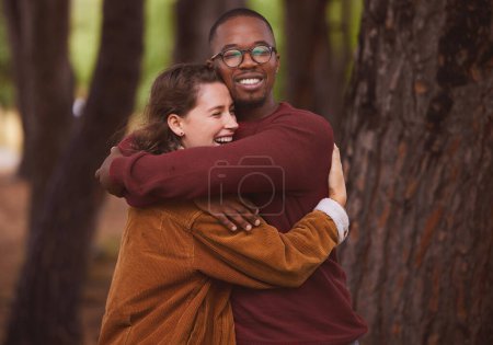 Photo for Love, hug and couple together in outdoor for camping in wilderness on anniversary date in Norway, countryside. Interracial people, travel and happiness on vacation in forest for peace and adventure - Royalty Free Image