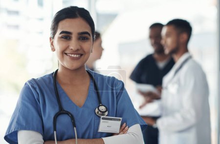 Photo for Portrait, confident nurse and happy woman in hospital for healthcare career, wellness and proud doctor. Face, smile and medical professional with arms crossed, surgeon or expert employee coworking. - Royalty Free Image