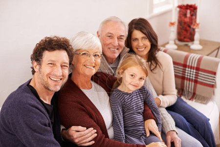 Photo for Grandparents, parents and kid on sofa for portrait with hug, care or love with generations for bonding in home. Mother, father and senior people with child for embrace on lounge couch in family house. - Royalty Free Image