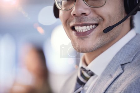 Photo for Face, man and satisfied as employee at call center with customer or client support and service. Contact, crm and mouth with microphone as consultant, smile or happy with job and career growth. - Royalty Free Image