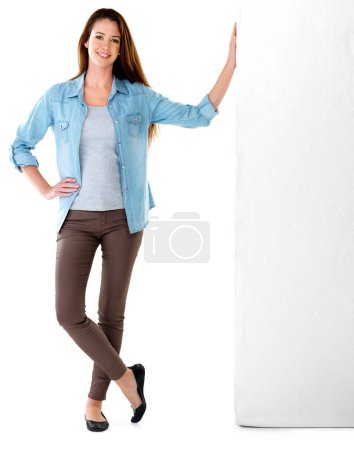 Photo for Fashion, denim and portrait of woman in studio leaning on wall for happiness, confidence or billboard with white background. Smile, mockup space and model with shirt, comfortable or trendy clothes. - Royalty Free Image