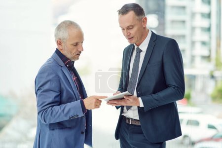 Photo for Business, digital tablet and mature men in office for progress report, proposal or project collaboration. Discussion, manager and employee with tech for kpi target, information or company updates. - Royalty Free Image