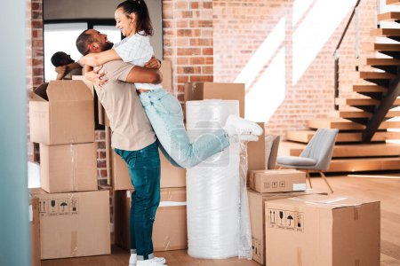 Photo for Moving, cardboard boxes and couple hug in new home for property investment, real estate or renting. Homeowner, happy man and woman embrace for mortgage loan, relocation or packages in apartment. - Royalty Free Image