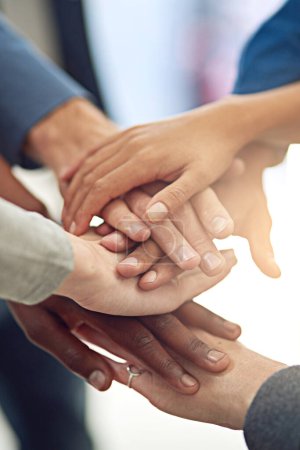 Business people, team and huddle for hands in stack, community and support or unity. Colleagues, pile and agreement in collaboration or alliance in workplace, solidarity and partnership in office.
