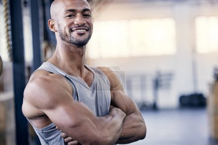 Photo for Man, portrait and arms folded in gym for workout with smile, training or exercise for fitness. Male person, confident or personal trainer in sports club or strong, cardio or wellness in Chicago. - Royalty Free Image