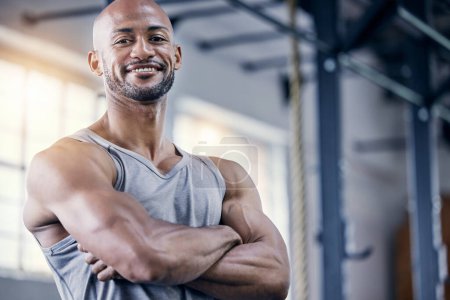 Photo for Man, portrait and arms crossed in gym for exercise with smile, training or workout for fitness. Male person, confident or personal trainer in sports club or strong, cardio or wellness in Chicago. - Royalty Free Image