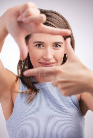 Photo for Woman, studio and frame hands with fingers, photography and profile picture or perspective with hand gesture. Focus, camera sign and portrait or looking, happy and confident face on background. - Royalty Free Image