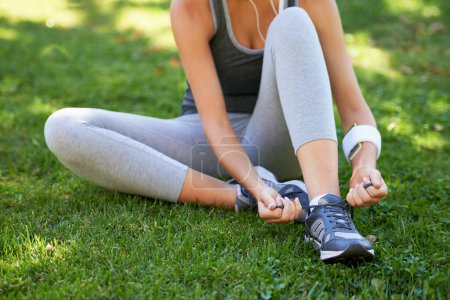 Photo for Sneakers, hands and tie shoelace on grass, ready for run or cardio for fitness and sports outdoor. Exercise, workout and person with shoes in park for training, health and wellness with runner. - Royalty Free Image