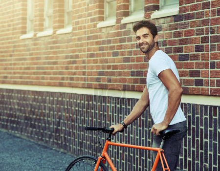 Photo for Smile, bicycle and portrait of man by brick wall in city for sightseeing on vacation or adventure. Happy, walking and male person with bike in town street on weekend trip or holiday in Netherlands - Royalty Free Image