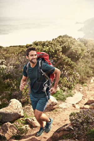 Photo for Man, hiking and happy for fitness, health and wellness with back and mountain. Athlete, exercise and adventure with summer, sunshine and backpack journey on cape town trail with travel and vacation. - Royalty Free Image