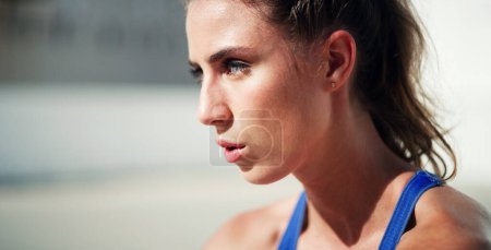 Photo for Thinking, tired and woman outdoor for fitness, health and workout in city for wellness on mockup space. Sports, face and person on break with fatigue, exhausted and relax after training for exercise. - Royalty Free Image