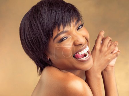 Photo for Portrait, skincare and playful black woman with tongue out, carefree and natural cosmetics in studio. Dermatology, beauty and happy girl with facial care, skin glow and laughing on brown background. - Royalty Free Image