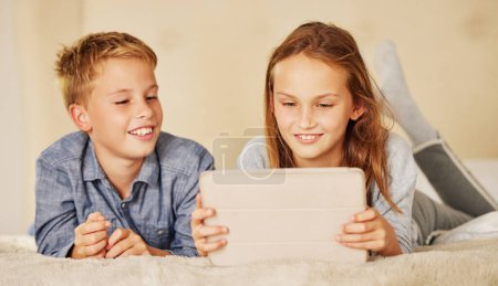 Photo for Family, bedroom and siblings with tablet for streaming movies, watching videos or bonding in home. Children, young brother and sister with technology for happiness, playing games or development. - Royalty Free Image