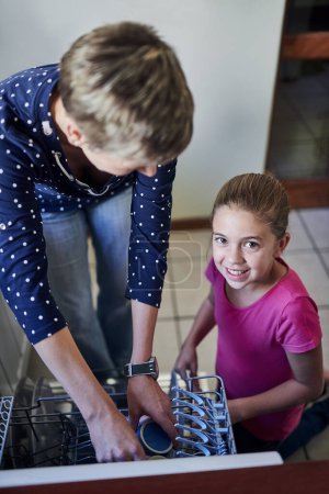 Photo for Dishwasher, mother and daughter in portrait cleaning kitchen together with help, learning or teaching. Housework, mom and girl in home washing dishes in machine with smile, support and morning chores. - Royalty Free Image
