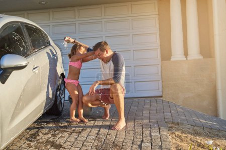 Photo for Happy, family and cleaning car together with water and fun outdoor in sunlight . Dad and young girl, with smile learning, growth and playing while washing outside with lens flare on summer holiday. - Royalty Free Image