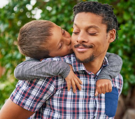 Photo for Father, kiss and child in backyard for love, care and happiness for piggy back. Black man, boy and embrace in garden for bonding, family and together in park for holiday or vacation in spring time. - Royalty Free Image
