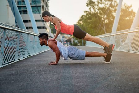 Photo for Couple, bridge and balance on back for fitness or daily exercise for training, pushup and workout partner for health. Man, girl and together outdoor for bonding for wellness or wellbeing and cardio - Royalty Free Image