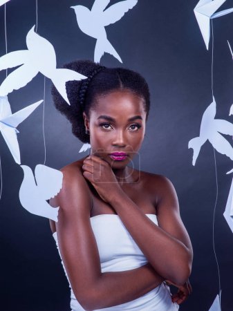 Photo for Black woman, origami and creative beauty for fashion, art and confidence or empower in studio with portrait. African girl, fantasy and makeup with paper birds for decor, design and cultural diversity. - Royalty Free Image