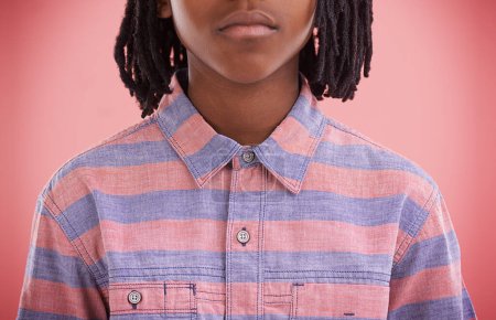 Photo for Fashion, child and shirt with style, trendy and modern clothing of a African boy in a studio. Youth, hipster and casual clothes with a kid and cool teen top with pink background and serious face. - Royalty Free Image