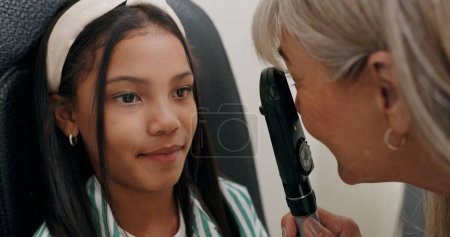Girl, optician and checkup for vision, healthcare and eye exam with retinoscope test. Patient, optometrist and technology for glaucoma, wellness and medical result with consultation and support.