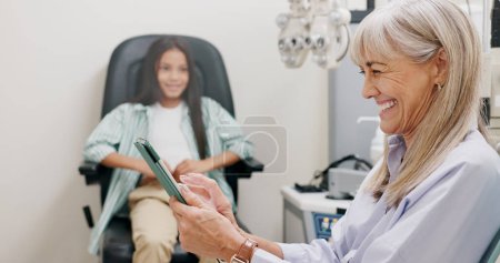 Photo for Tablet, doctor and smile for video call, clinic and patient in office for eye care, kid and specialist. Communication, online and visual healthcare, information and optician with child and exam. - Royalty Free Image